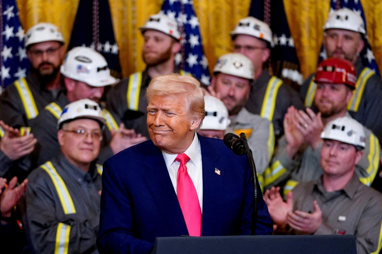 FILE PHOTO: U.S. President Donald Trump signs executive orders in Washington
