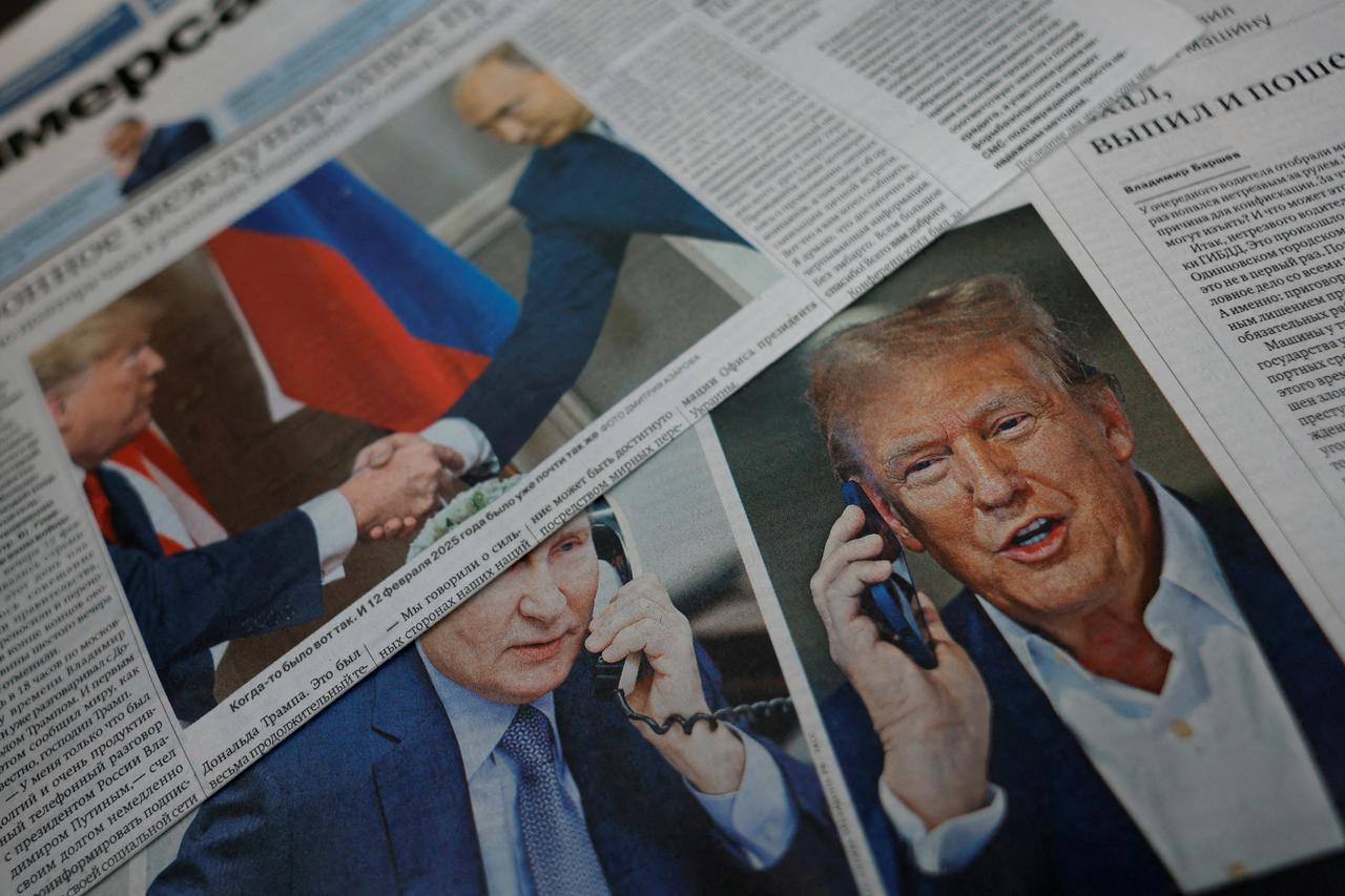 FILE PHOTO: View of newspaper covers dedicated to Putin-Trump phone call at newsstand in Moscow