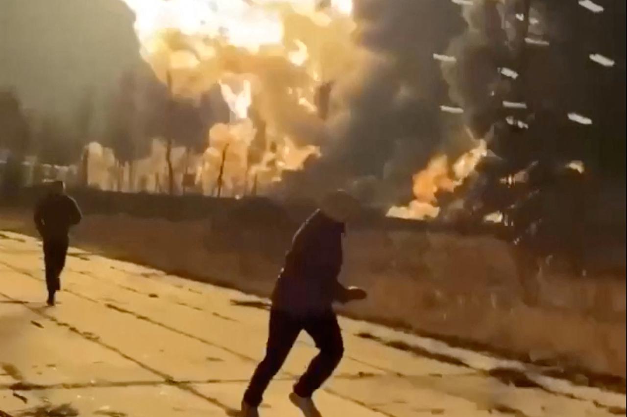 People run as smoke rises from an explosion during what the governor of Russia's Ryazan region southeast of Moscow describes as an air attack, in Ryazan