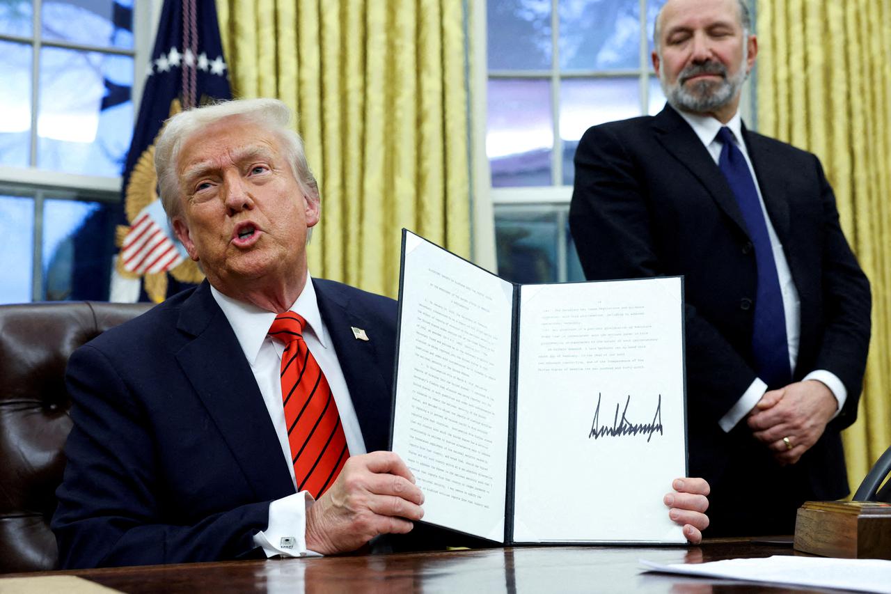 FILE PHOTO: U.S. President Donald Trump signs an executive order in the Oval Office of the White House in Washington